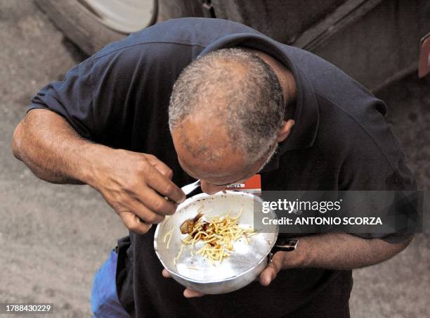 Petroleum product tanker truck driver eats outside the Duque de Caxias refinery, some 70km from Rio de Janeiro 02 May 2002 at the start of a 24-hour...