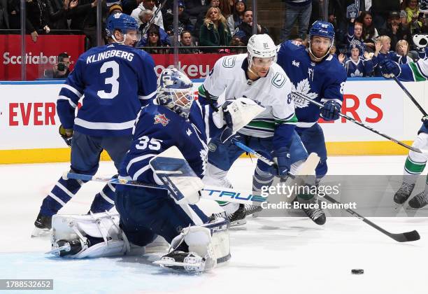 Ilya Samsonov of the Toronto Maple Leafs makes a save in the last minute of play as Dakota Joshua of the Vancouver Canucks looks for the rebound at...