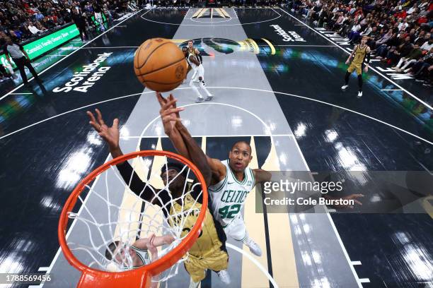 Chris Boucher of the Toronto Raptors drives to the net against Al Horford of the Boston Celtics during the first half of their NBA In-Season...