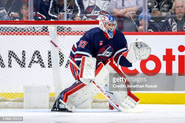 Goaltender Connor Hellebuyck of the Winnipeg Jets guards the net during second period action against the Buffalo Sabres at the Canada Life Centre on...