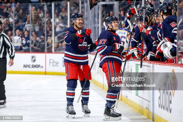 Brenden Dillon and Nikolaj Ehlers of the Winnipeg Jets are all smiles as they celebrate a second period goal against the Buffalo Sabres with...