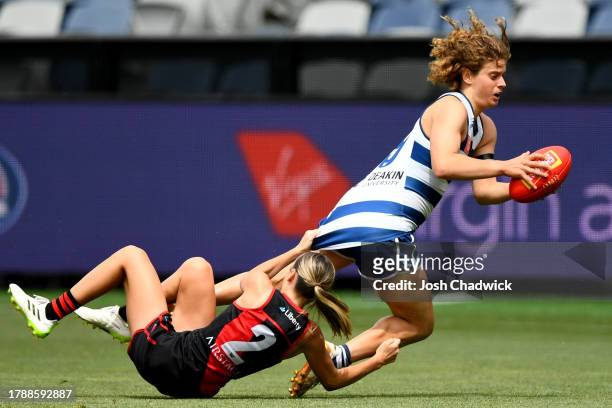 Nina Morrison of the Cats is tackled by Georgia Gee of the Bombers during the AFLW Second Elimination Final match between Geelong Cats and Essendon...