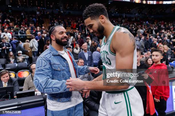 Rapper Drake greets Jayson Tatum of the Boston Celtics after their NBA In-Season Tournament game against the Toronto Raptors at Scotiabank Arena on...