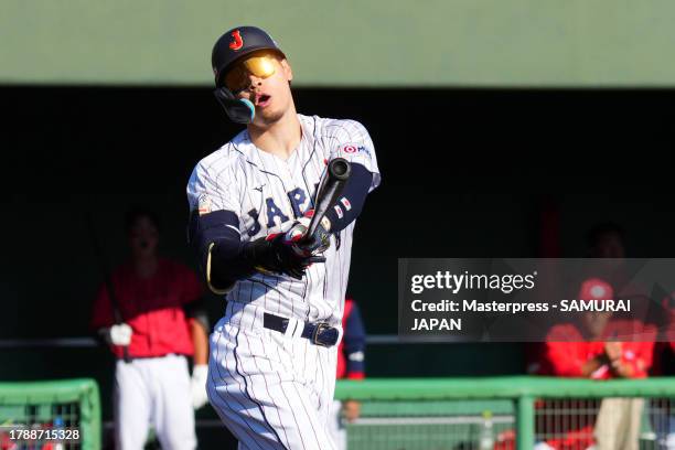 Infielder Teruaki Sato of Samurai Japan strikes out in the 5th inning during a practice game between Samurai Japan and Hiroshima Carp at SOKKEN...