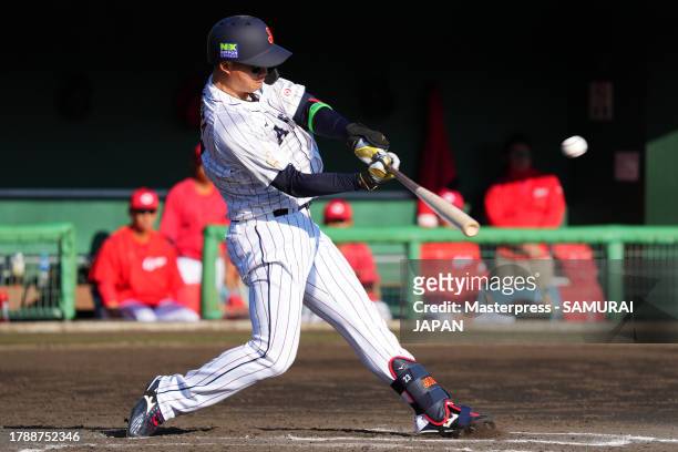 Outfielder Shota Morishita of Japan hits a solo home run in the 6th inning during a practice game between Samurai Japan and Hiroshima Carp at SOKKEN...