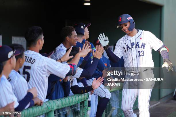 Outfielder Shota Morishita of Japan celebrates with teammates after hitting a solo home run in the 6th inning during a practice game between Samurai...