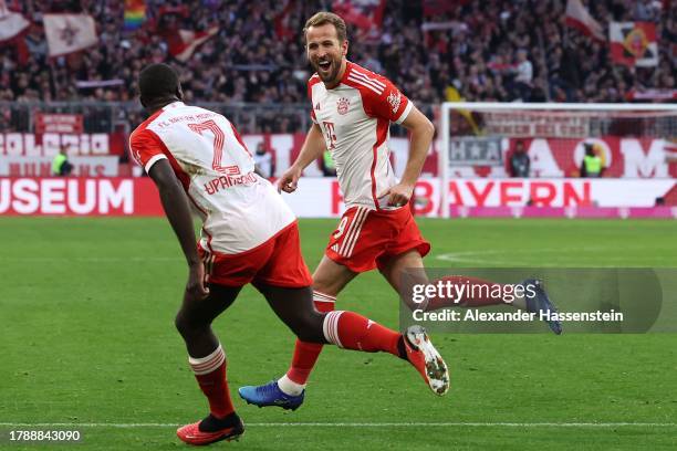 Harry Kane of Bayern Munich celebrates with teammate Dayot Upamecano after scoring the team's second goal during the Bundesliga match between FC...