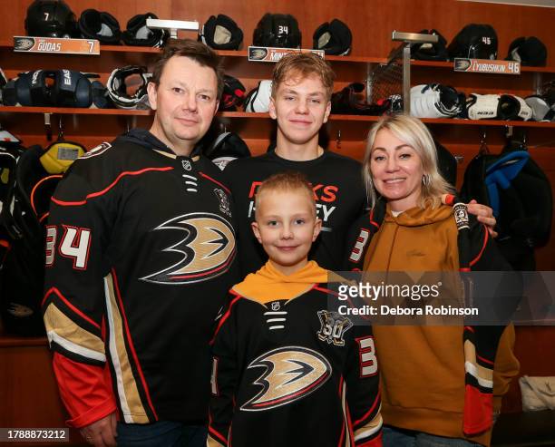 Pavel Mintyukov of the Anaheim Ducks poses for a photo with his family after the game against the Florida Panthers at Honda Center on November 17,...