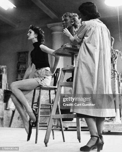 Model Susan Parker sits for sculptor Kay Sullivan as Sullivan sculpts a head for a new mannequin to be used in store window displays, in New York...