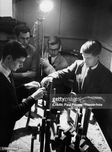 Tutor George Haslam observes students during a design-for-TV class, with a model set arranged on the table before them at the Royal College of Art,...