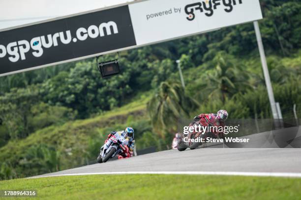 Enea Bastianini of Italy and Ducati Lenovo Team rides in front of Alex Marquez of Spain and Gresini Racing MotoGP during the Race of the MotoGP...