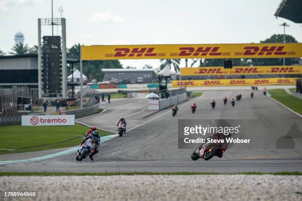 Enea Bastianini of Italy and Ducati Lenovo Team leads in front of Alex Marquez of Spain and Gresini Racing MotoGP and Francesco Bagnaia of Italy and...