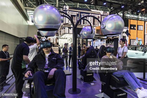 Attendees wear virtual reality headsets at the Lynk & Co pavilion at the Guangzhou Auto Show in Guangzhou, China, on Friday, Nov. 17, 2023. China is...