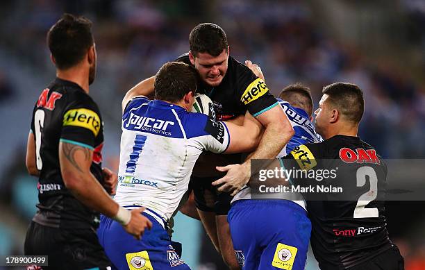Lachlan Coote of the Panthers is tackled during the round 25 NRL match between the Canterbury Bulldogs and the Penrith Panthers at ANZ Stadium on...