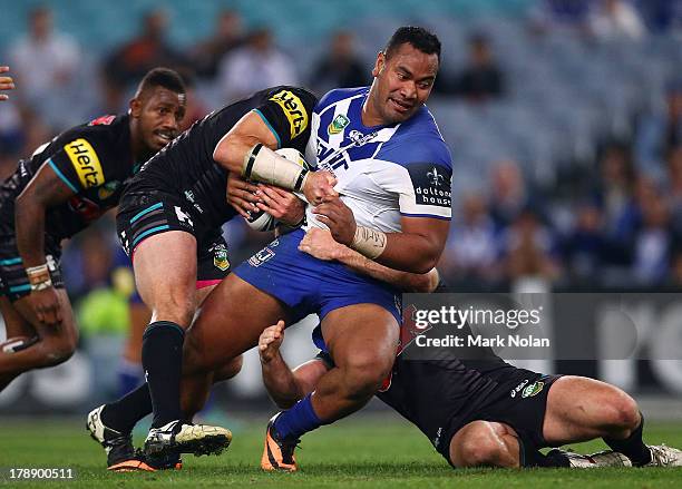 Tony Williams of the Bulldogs is tackled during the round 25 NRL match between the Canterbury Bulldogs and the Penrith Panthers at ANZ Stadium on...