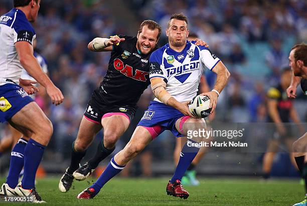 Josh Reynolds of the Bulldogs looks to pass during the round 25 NRL match between the Canterbury Bulldogs and the Penrith Panthers at ANZ Stadium on...