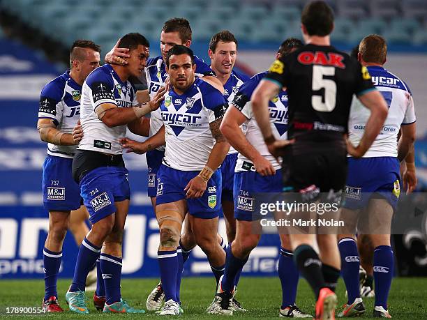 Tim Lafai of the Bulldogs is congratulated after scoring during the round 25 NRL match between the Canterbury Bulldogs and the Penrith Panthers at...