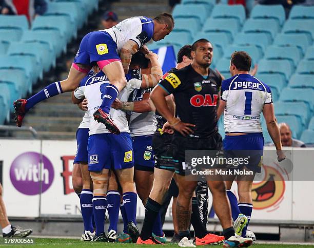 The Bulldogs celebrate a try by Tim Lafai of during the round 25 NRL match between the Canterbury Bulldogs and the Penrith Panthers at ANZ Stadium on...