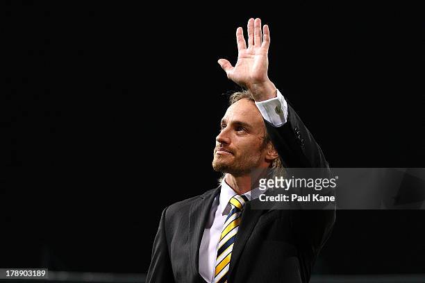 Mark Nicoski of the Eagles waves to the crowd while walking a lap of honour after announcing his retirement from the game during the round 23 AFL...