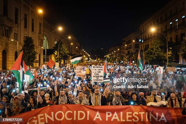 Protesters use their cell phone flashlight during the demonstration on November 11, 2023 in Barcelona, Spain. Thousands of people have demonstrated...