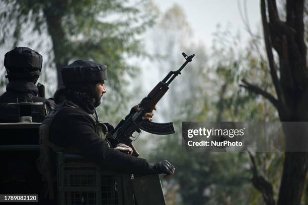 Indian armymen are seen near the site of gun-battle in Samnu village in Kulgam district on November 17, 2023. Five militants were killed in a...