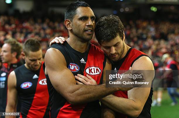 Nathan Lovett-Murray of the Bombers is consoled by Ben Howlett after playing his last game during the round 23 AFL match between the Essendon Bombers...