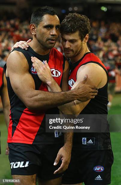 Nathan Lovett-Murray of the Bombers is consoled by Ben Howlett after playing his last game during the round 23 AFL match between the Essendon Bombers...