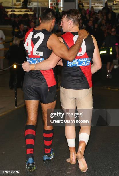 Nathan Lovett-Murray of the Bombers is consoled by Brendon Goddard after playing his last game during the round 23 AFL match between the Essendon...