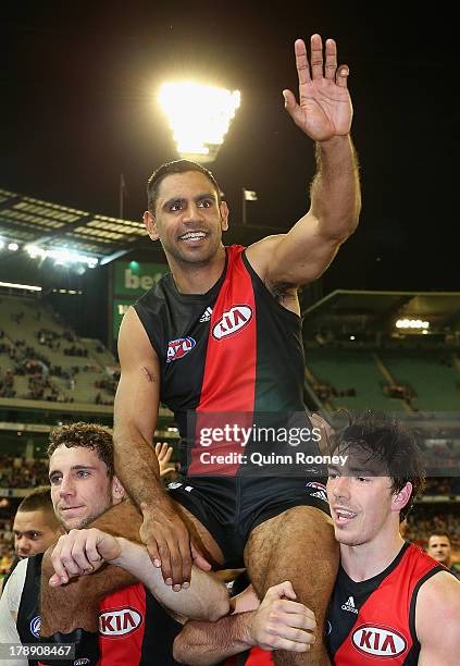 Nathan Lovett-Murray of the Bombers is chaired off the ground after playing his last game during the round 23 AFL match between the Essendon Bombers...