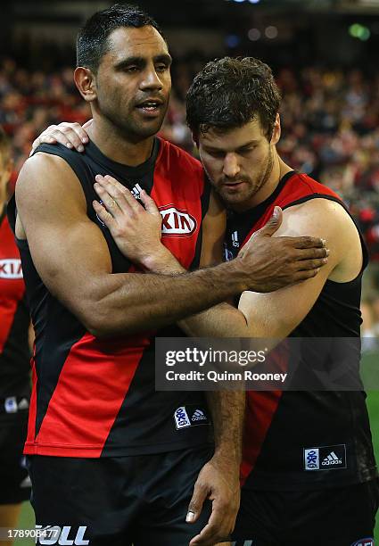 Nathan Lovett-Murray of the Bombers is consoled by Ben Howlett after playing his last game during the round 23 AFL match between the Essendon Bombers...