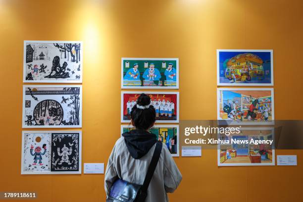 Visitor views artwork during the 10th China Shanghai International Children's Book Fair in east China's Shanghai, Nov. 17, 2023. The 10th China...