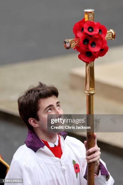 Boy carries a poppy covered cross during the National Service of Remembrance at The Cenotaph on November 12, 2023 in London, England. Every year,...