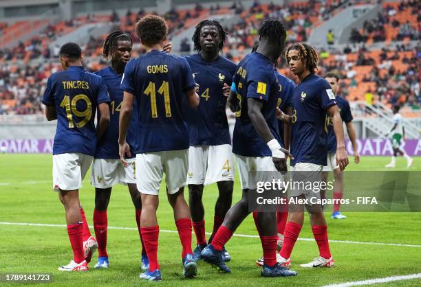Tidiam Gomis of France celebrates with teammates after scoring the team's third goal from the penalty spot during the FIFA U-17 World Cup Group E...