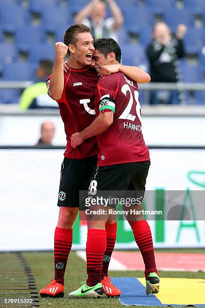 Artur Sobiech of Hannover celebrates with team-mate Lars Stindl after scoring their teams second goal during the Bundesliga match between Hannover 96...