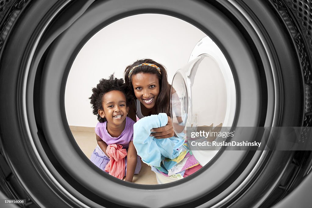 Mother and daughter doing laundry.