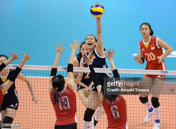 Chunlei Zeng of China spikes the ball during day four of the FIVB World Grand Prix Sapporo 2013 match between Japan and China at Hokkaido Prefectural...