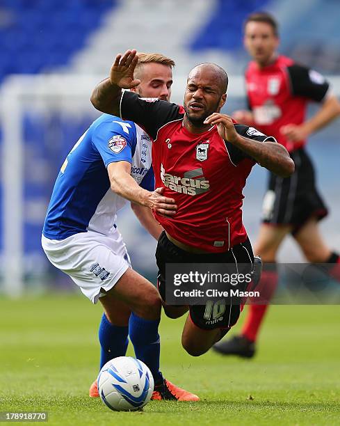 David McGoldrick of Ipswich Town is tackled by Andrew Shinnie of Birmingham City during the Sky Bet Championship match between Birmingham City and...