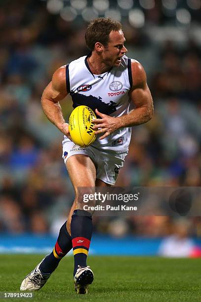 Ben Rutten of the Crows looks to pass the ball during the round 23 AFL match between the West Coast Eagles and the Adelaide Crows at Patersons...