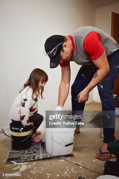 little girl helping her father in home improvement. - dirty construction worker stock pictures, royalty-free photos & images