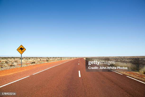 kangaroo warning sign on highway. australia - australia road stock pictures, royalty-free photos & images