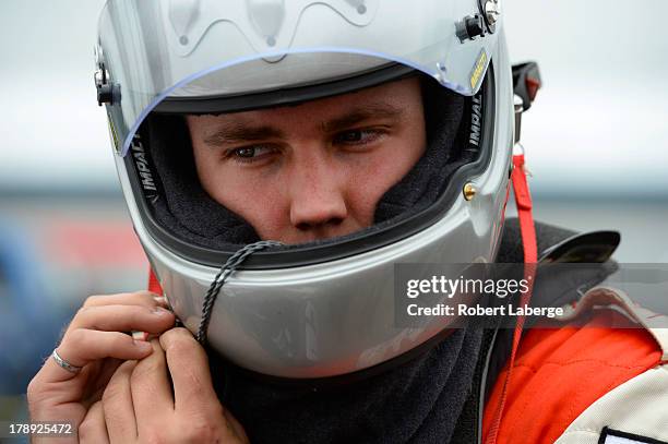 Joey McColm of Canada, driver of the TSC Stores Dodge, in the garage area during practice for the NASCAR Canadian Tire Series presented by Mobil 1...