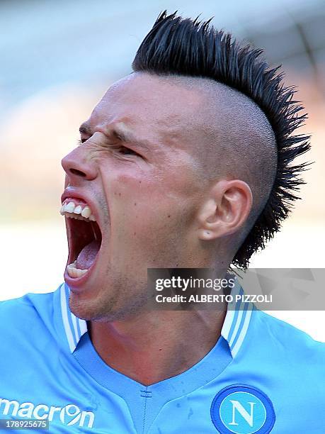 Napoli's midfielder Marek Hamsik of Slovakia celebrates after scoring during the Italian Serie A football match Chievo vs Napoli on August 31, 2013...