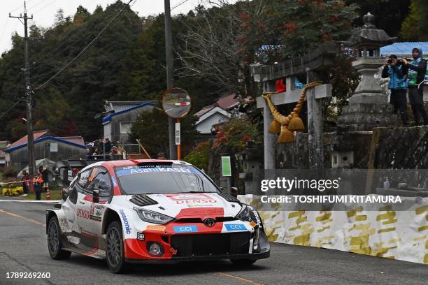 Elfyn Evans and his co-driver Scott Martin of Great Britain drive their Toyota GR Yaris Rally1 Hybrid past the Kumano shrine during SS10 Lake...