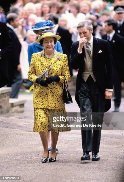 Queen Elizabeth II and Angus Ogilvy attend the wedding of their son James Ogilvy and Julia Rawlinson at St. Mary The Virgin Church on July 30, 1988...