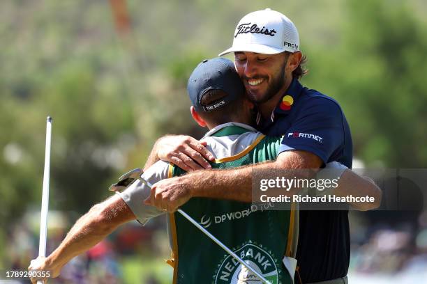 Max Homa of the United States celebrates victory with his caddie after winning the tournament on the 18th green during Day Four of the Nedbank Golf...