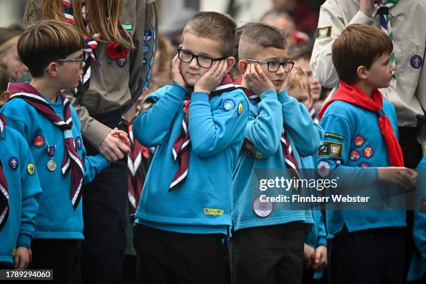 Boys react to the cannon firing the salute at the Remembrance Day Sunday service, wreath laying and parade at the Cenotaph, on November 12, 2023 in...