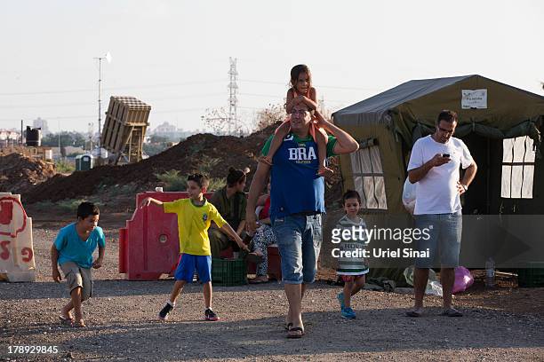 An Israeli family arrives to watch the 'Iron Dome' missile defense system as it is deployed on August 31, 2013 in Tel Aviv, Israel. Tensions are...