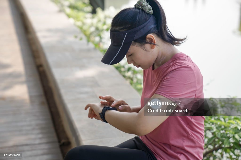 Day in the life of young woman with Continuous glucose monitor resting after work out sport outdoor