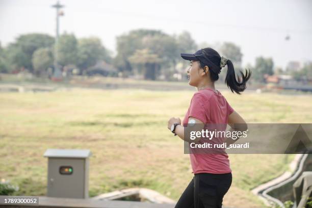 a female with cgm jogging for exercise - blood sugar test stock pictures, royalty-free photos & images