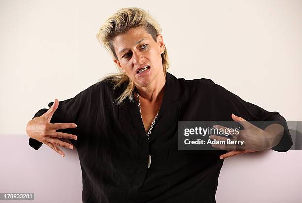 Canadian electronic musician and performance artist Peaches poses while sitting in the 'live exhibit' portion of the exhibition 'The Whole Truth -...
